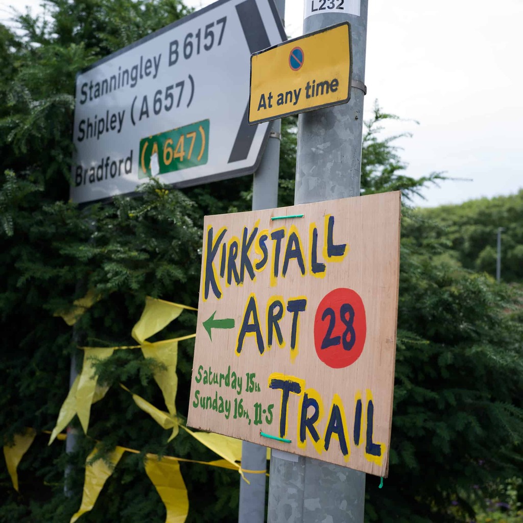 a photograph of a sign for Kirkstall Art Trail attached to a lamp post.