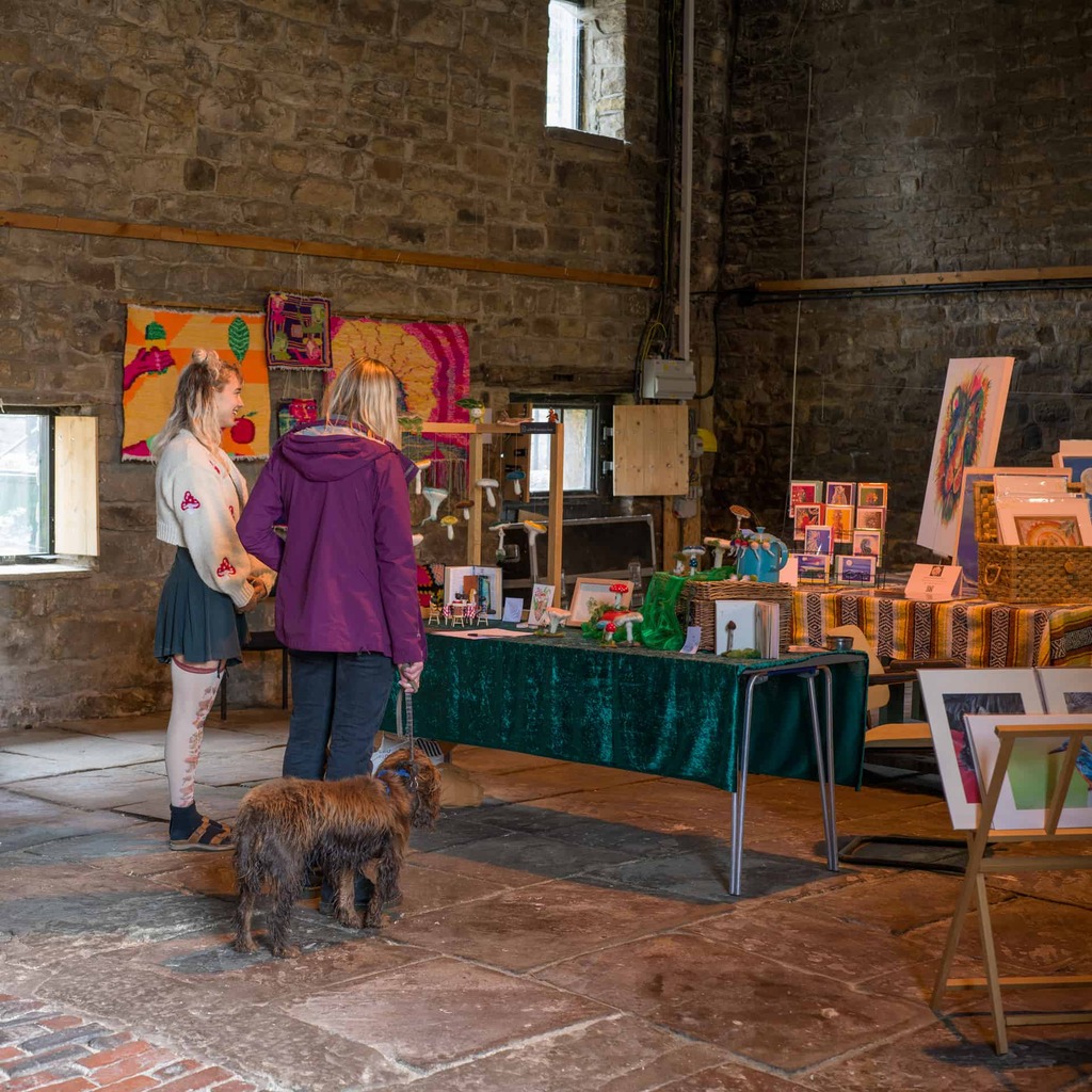 A photograph of visitors, with their dog, to Hollybush during the art trail in 2023.