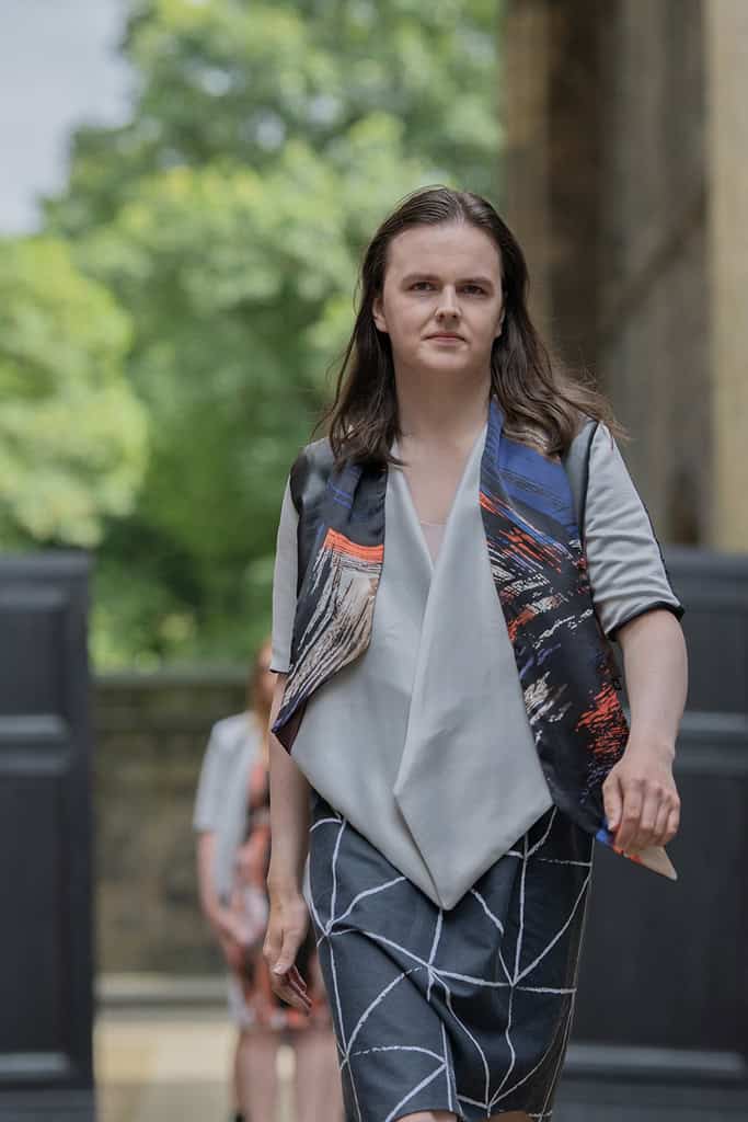 The model wears a dress and and scarf