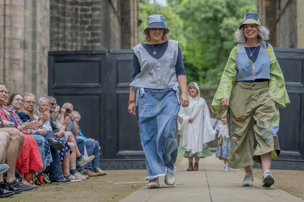 Two models wear bucket hats that match their outfits. One models a top and long skirt, and the other a long sleeve top and cropped trousers