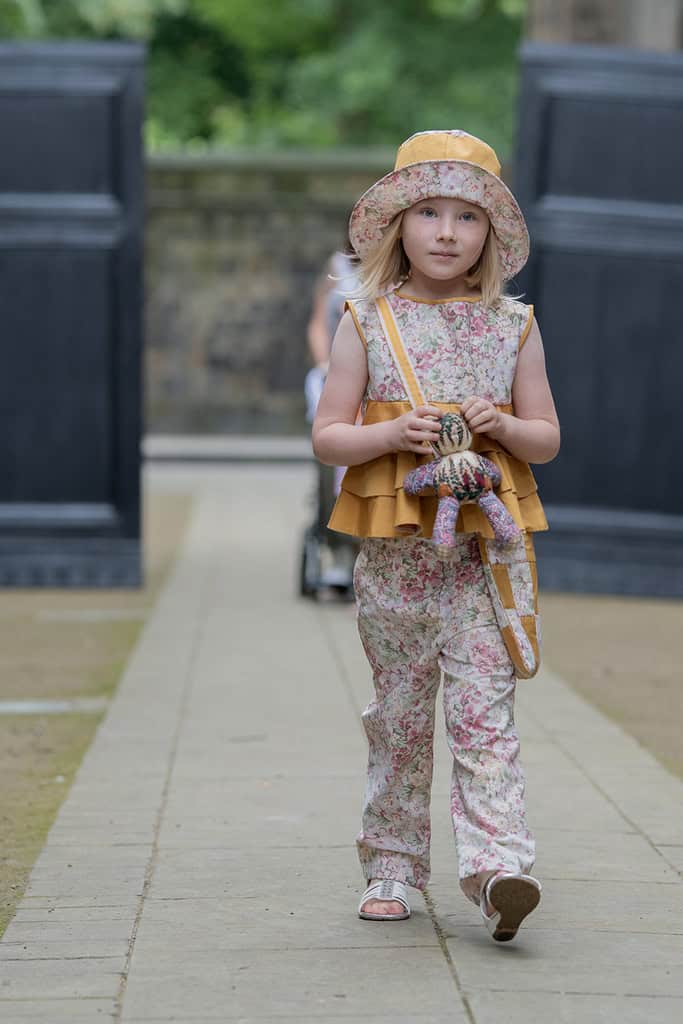 A young girls models matching trousers and top
