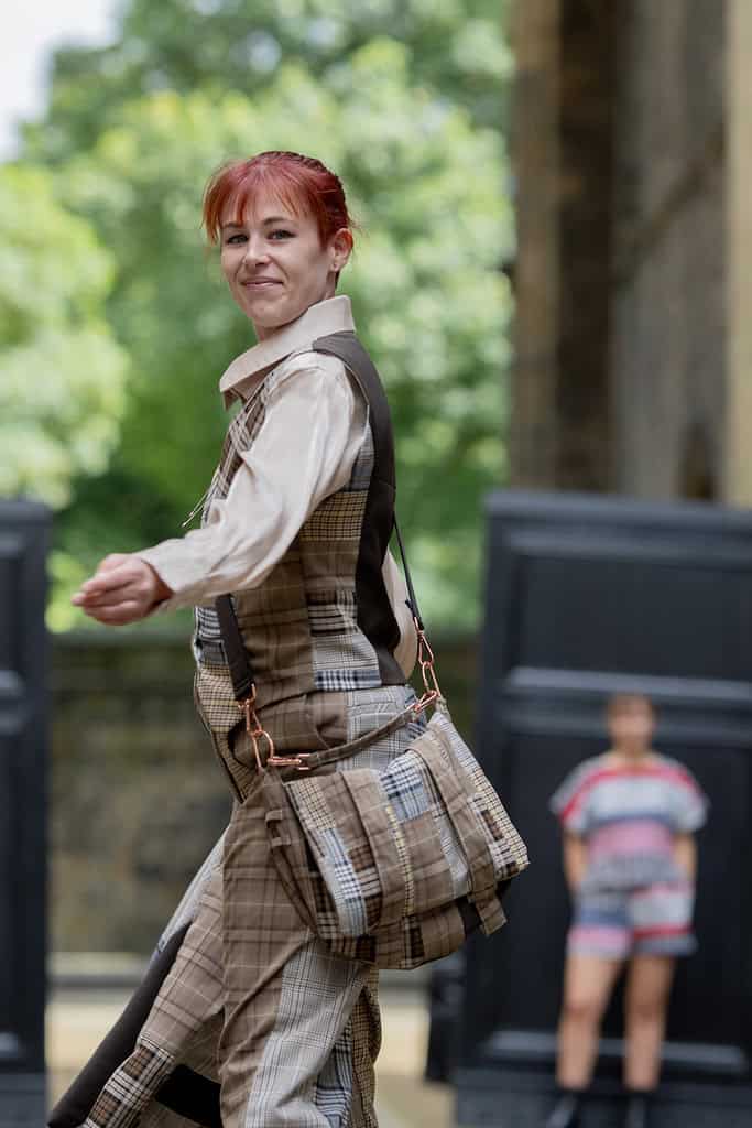 The model wears a suit made out of different pairs of trousers