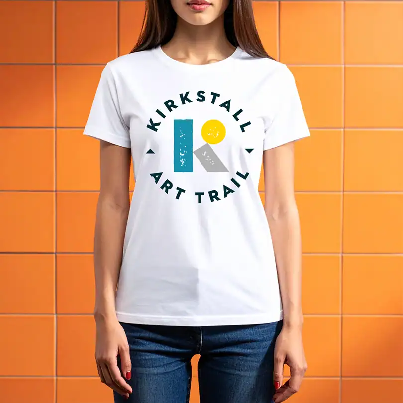 a person wears a white t-shirt with the new Kirkstall Art Trail logo